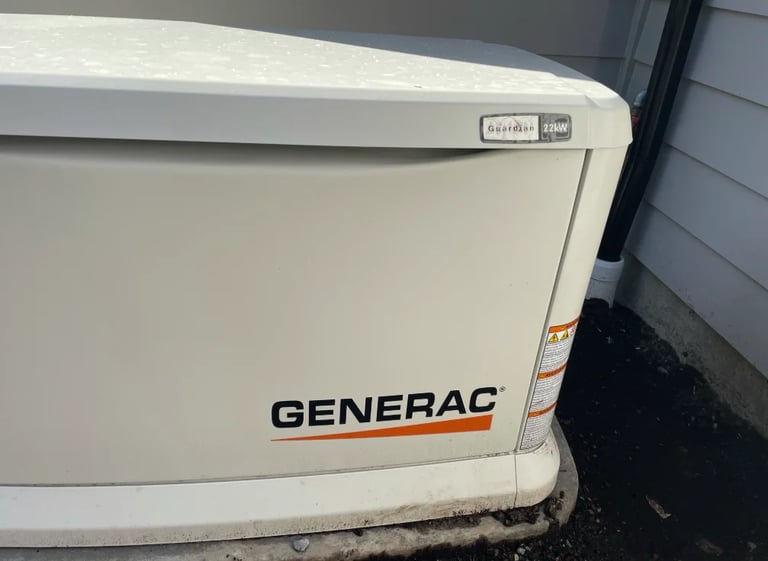 White Generac standby generator mounted on exterior wall or pad near building
